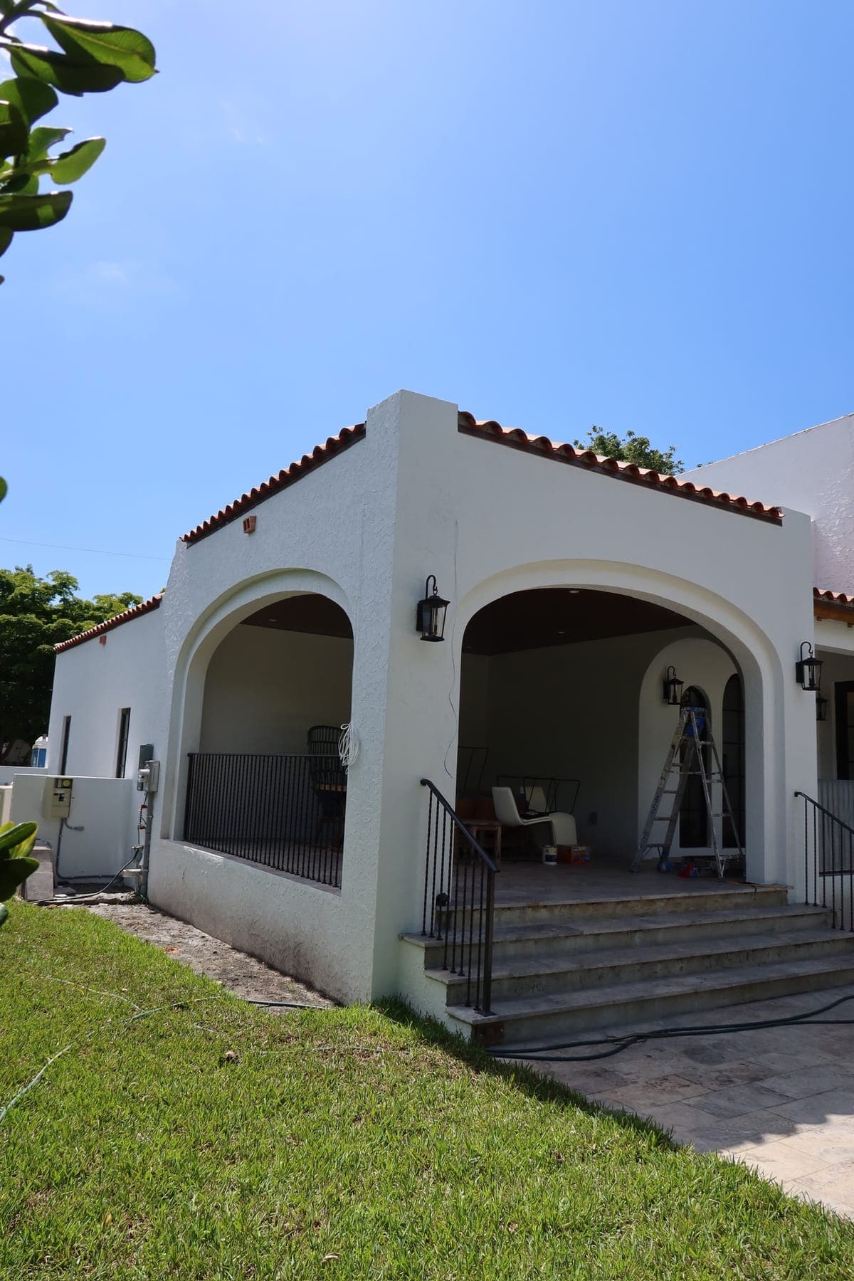 Mediterranean home with a barrel tile roof and arched porch.