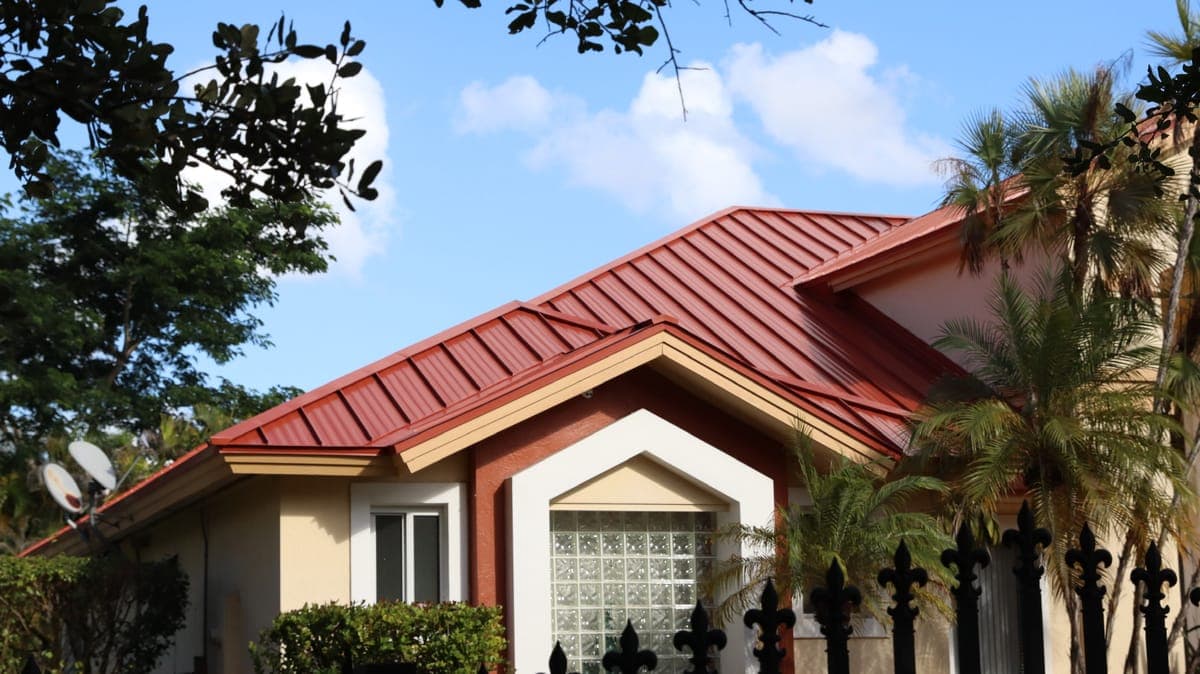 Home with a red standing-seam metal roof.