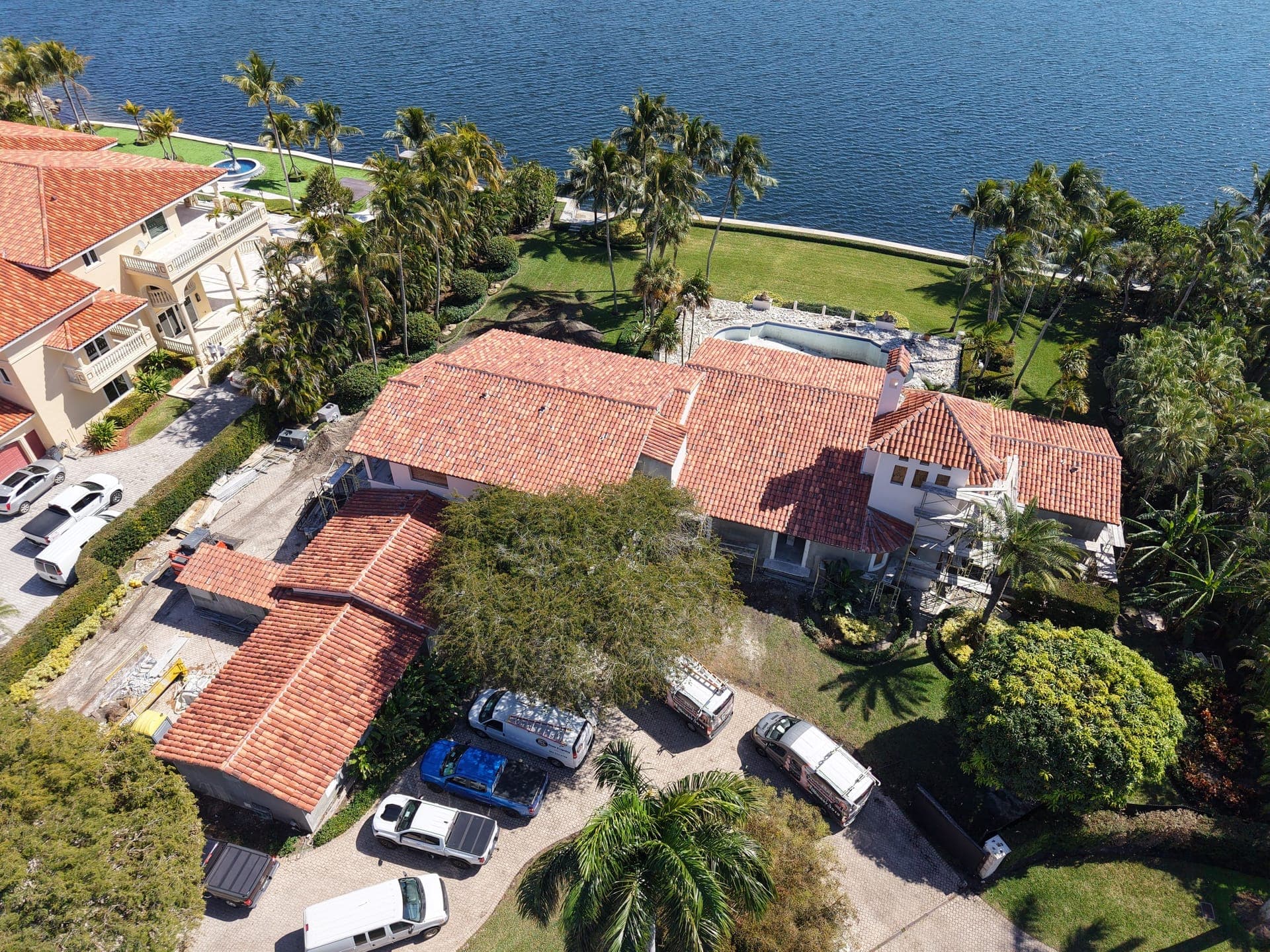 Aerial view of a tile-roofed waterfront estate in South Florida.