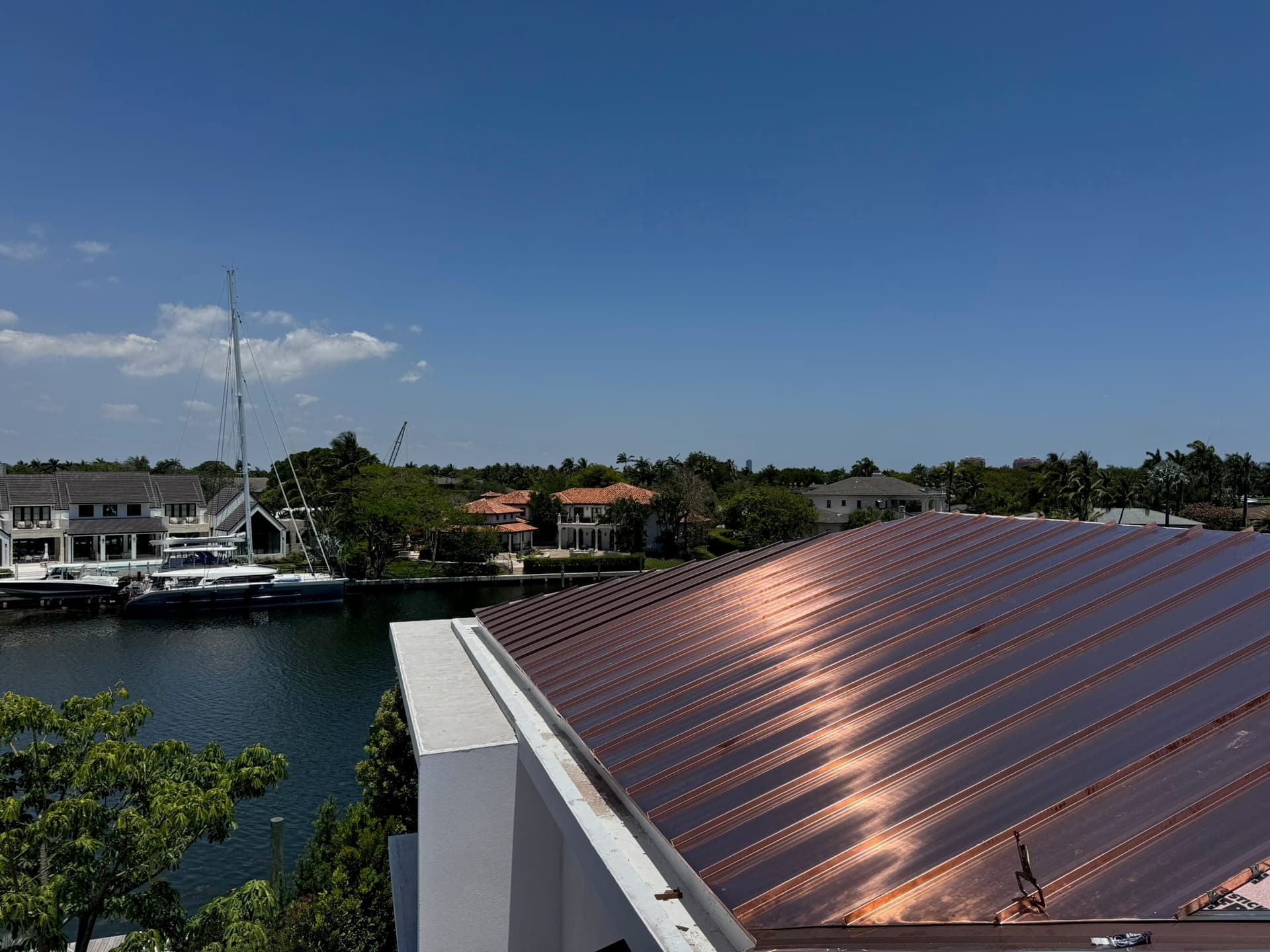 Copper standing-seam metal roof on a waterfront home.