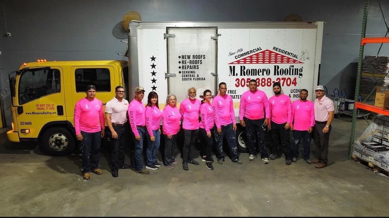 The M. Romero's Roofing crew standing in front of the company box truck at the Hialeah shop.